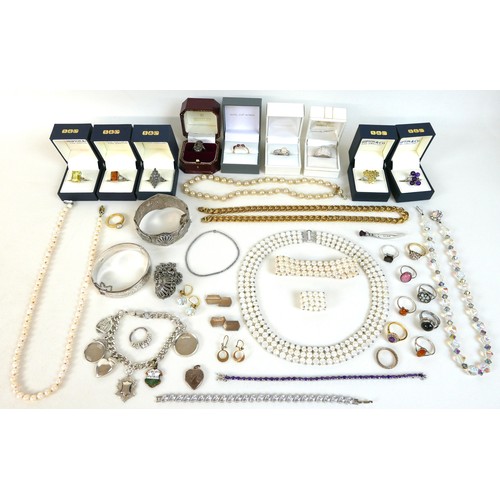 144 - A collection of costume jewellery, including a quantity of dress rings, a silver bangle and charm br... 