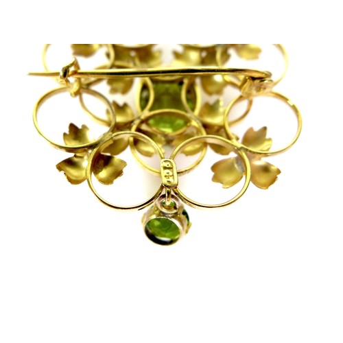 164 - A 9ct gold and green stone openwork brooch, 2.9 by 3.3cm, the lower drop stone of darker hue and mos... 