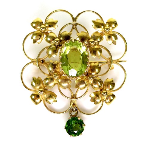 164 - A 9ct gold and green stone openwork brooch, 2.9 by 3.3cm, the lower drop stone of darker hue and mos... 