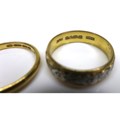 269 - Two 22ct yellow gold rings, one with engraved floral decoration and platinum edging, WWLd, London 19... 