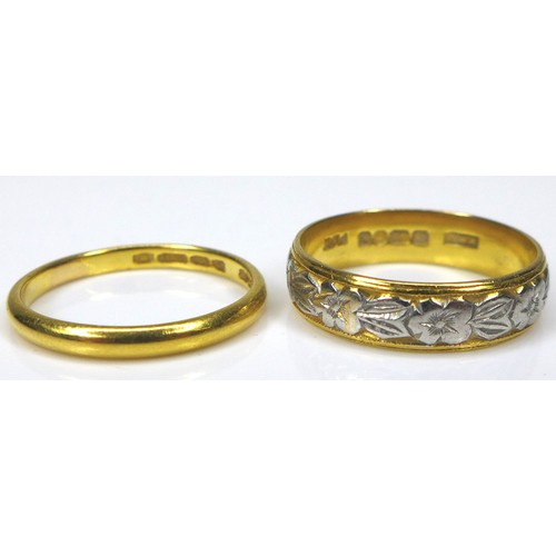 269 - Two 22ct yellow gold rings, one with engraved floral decoration and platinum edging, WWLd, London 19... 