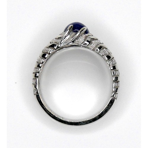 258 - A 14K white gold ring set with a star sapphire, 3.5 by 6.0mm, size S, 6.2g.