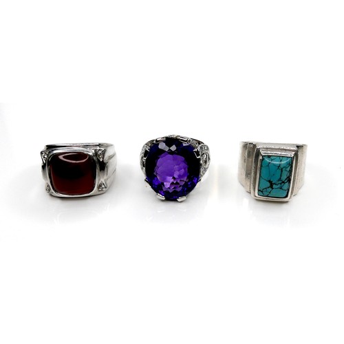 200 - A group of three silver rings, one set with a large amethyst, 20 by 17 by 10mm, size X, 14.8g, one s... 