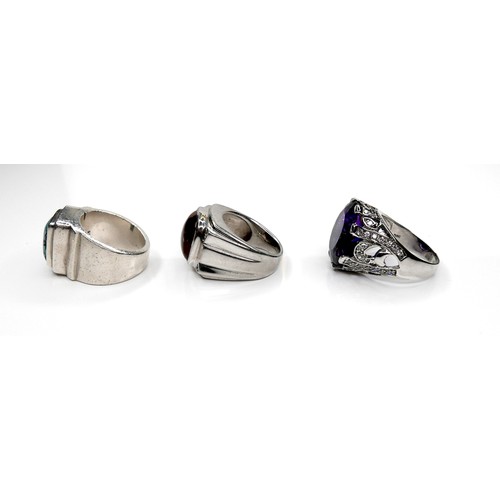 200 - A group of three silver rings, one set with a large amethyst, 20 by 17 by 10mm, size X, 14.8g, one s... 