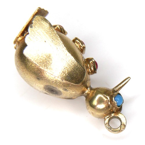 214 - An 18ct yellow gold novelty pendant, in the form of a penguin, with turquoise eyes and three red cor... 