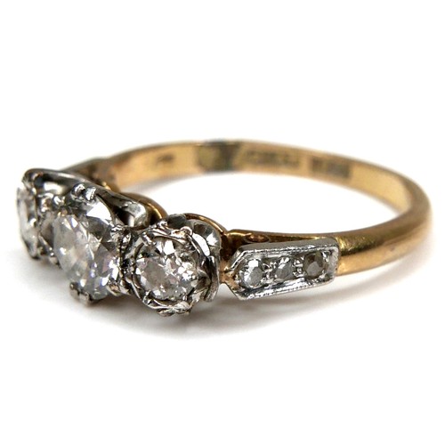 291 - An 18ct yellow gold, platinum, and diamond three stone ring, the central largest round brilliant cut... 