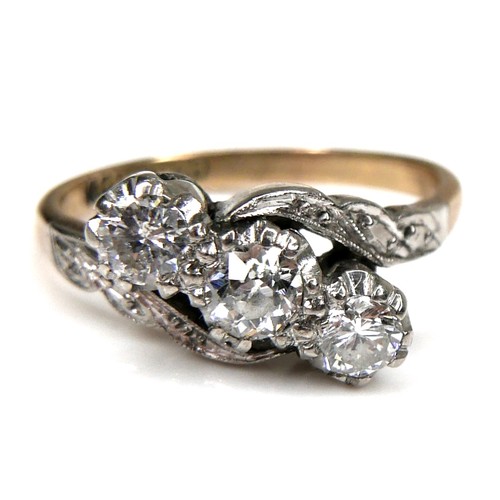 266 - An 18ct yellow gold, platinum, and diamond three stone ring, set in an angled row, the central large... 