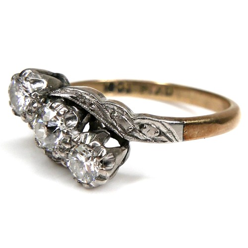 266 - An 18ct yellow gold, platinum, and diamond three stone ring, set in an angled row, the central large... 