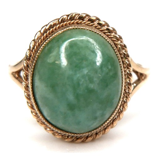 178 - A 9ct yellow gold and jade set ring, the oval cabochon cut jade 11.8 by 9.8mm, in rub over setting w... 