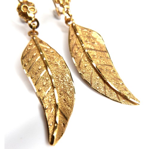 217 - A pair of Lebanese 21ct yellow gold earrings, of leaf form, hanging from a loop, each leaf 11 by 32m... 