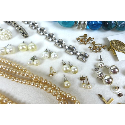 153 - A collection of costume jewellery, including brooches, necklaces, cufflinks, and a mother of pearl s... 