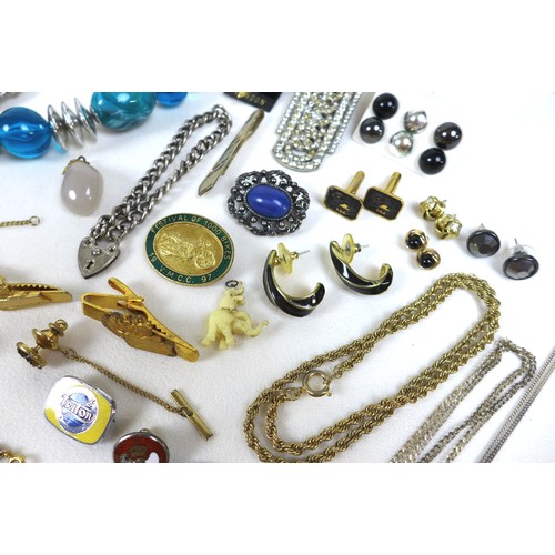 153 - A collection of costume jewellery, including brooches, necklaces, cufflinks, and a mother of pearl s... 