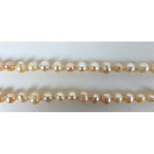 156 - A group of three 'flapper' pearl necklaces, all with no clasps, misshapen but mainly round pearls, t... 