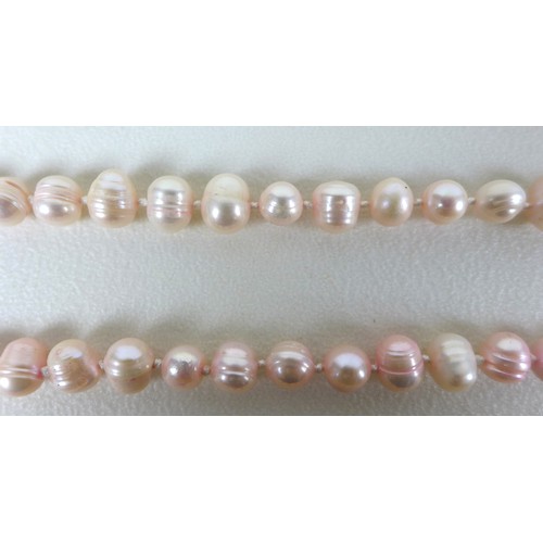 156 - A group of three 'flapper' pearl necklaces, all with no clasps, misshapen but mainly round pearls, t... 