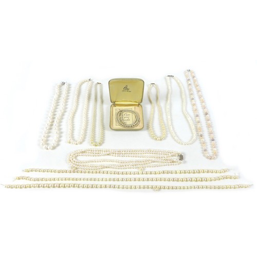 157 - A group of pearl necklaces, including a three strand cultured pearl necklace with silver clasp, a sh... 