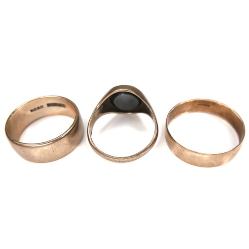 235 - Three 9ct gold rings, including a signet ring with polished dark stone insert, 12.1g overall. (3)