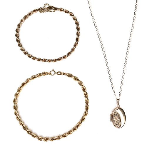 185 - Three pieces of 9ct gold jewellery, comprising an oval locket pendant, 1 by 2cm, with chain necklace... 