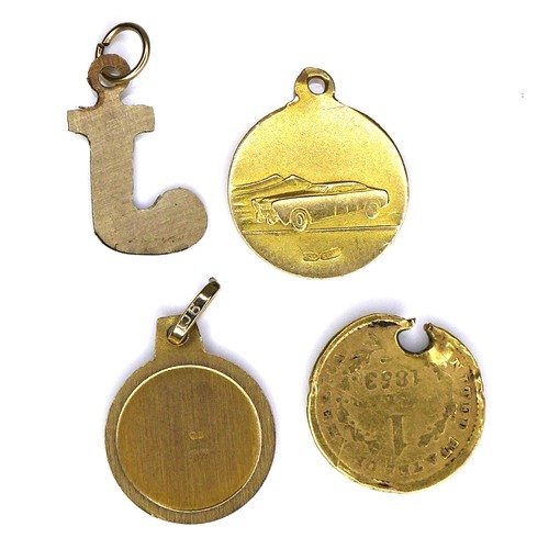 207 - A group of four gold charms, three circular, comprising an 18ct gold St Christopher charm, 13.5mm, 1... 