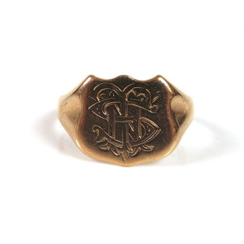 172 - A 9ct yellow gold signet ring, the shield engraved with a monogram 'THS', size R, 3.8g.