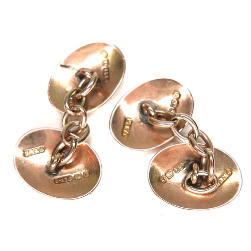 179 - A pair of Victorian 9ct yellow gold cufflinks, of convex oval form with chain links and engraved flo... 