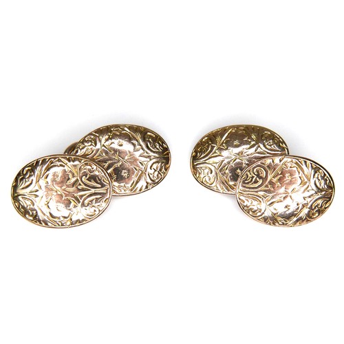 179 - A pair of Victorian 9ct yellow gold cufflinks, of convex oval form with chain links and engraved flo... 