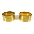 A pair of George V 9ct gold napkin rings, one engraved 'J.H. 1873-1923' the other 'M.H. 1873-1923', ... 