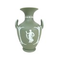 A Wedgwood Jasperware dip green vase, of baluster form with twin handles, decorated with female figu... 