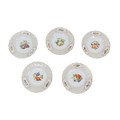 Five early 20th century continental hand-painted plates, each decorated with fruit and foliage with ... 