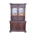 A large oak bookcase, early 20th century, the upper section with twin glazed doors below a stepped c... 