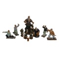 A group of Chinese 'mud man' figurines, in various poses, largest 25cm high, together with a Wade Wh... 