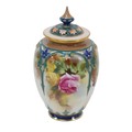 A Royal Worcester lidded vase, with pierced lid, decorated with colourful flowers with gilt highligh... 