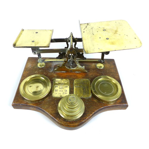 85 - A collection of copper and brass items, including a large set of postal scales with brass weights, o... 