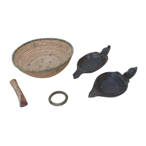 67 - A collection of tribal items, including two carved hardwood libation cups with beast headed handles ... 