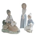 A Lladro figurine of a girl bottle feeding lamb, 17 by 13.5 by 17cm high together with another Lladr... 
