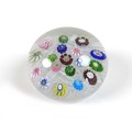 A Clichy paperweight, mid 19th century, with multicoloured roses amongst white cane work, 5.5cm diam... 