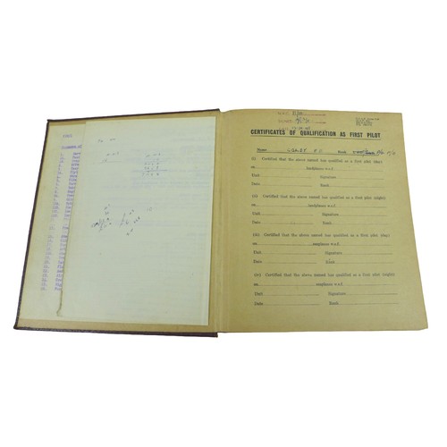 66 - A WWII pilot's log book, together with other military related ephemera/books. (1 bag)