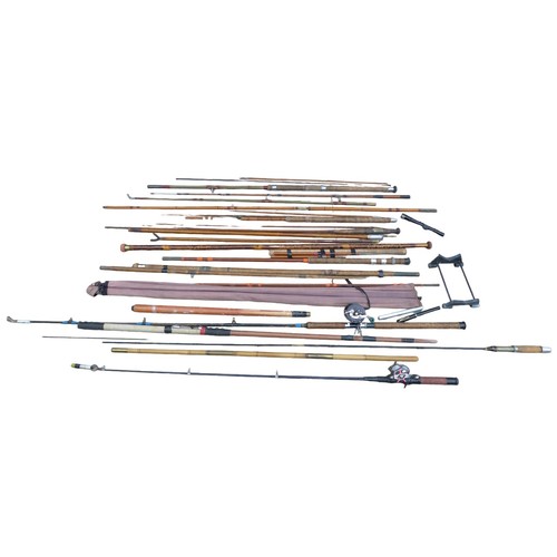 79A - A group of vintage fishing rods, predominately split cane fishing poles, two with reels, including a... 