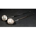 Two 18th century silver toddy ladles, one with a baleen twist handle, the bowl inset with silver Geo... 