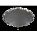 A George VI silver salver, with Chippendale pie-crust rim, raised upon three paw feet, Alexander Cla... 