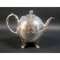 A Victorian silver teapot, of ovoid form with gord finial, floral engraved decoration, and ivory ins... 