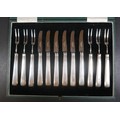 A George V silver handled set of twelve fruit knives and forks, with stainless steel blades and tine... 