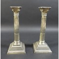 A pair of silver candlesticks, the composite style columns with Corinthian capitals and removable dr... 