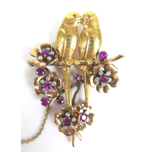 259 - An 18ct yellow gold brooch, modelled as a pair of kissing parakeets on a branch, surrounded by five ... 