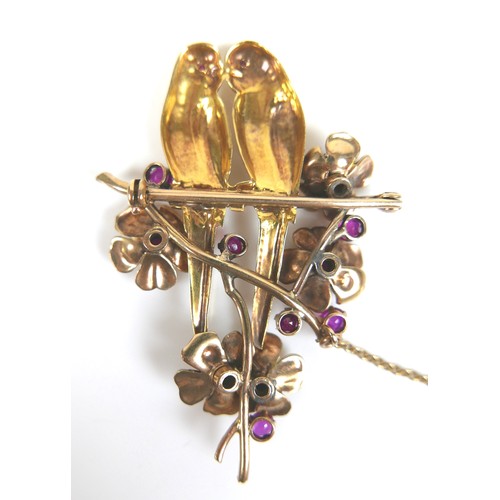 259 - An 18ct yellow gold brooch, modelled as a pair of kissing parakeets on a branch, surrounded by five ... 