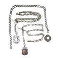 A group of silver Albert chains and fobs, comprising two silver chains, including a George V chain w... 