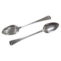 Two George IV old English pattern silver serving spoons, comprising a spoon with 'MC' monogram engra... 