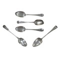 Five pieces of Georgian silver table spoons, including a George III spoon with bright cut decoration... 