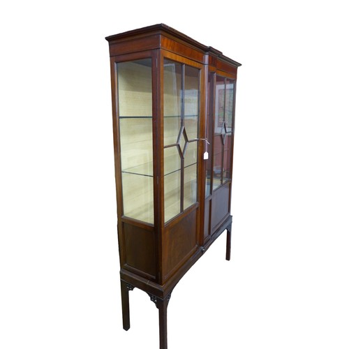 399 - An Edwardian mahogany display cabinet, twin doors enclosing two glass shelves, 116 by 31.5 by 181cm ... 