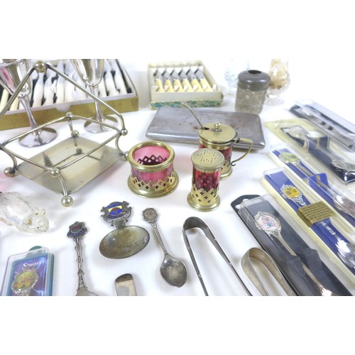 73 - A group of white metal and silver plated wares, including a number of spoons, some cranberry glass i... 