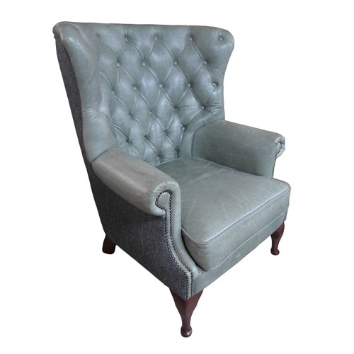 436 - A wingback armchair, recently re-upholstered in grey buttoned leather to the front and Harris tweed ... 